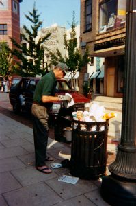 Julian-cleaning-up-overflowing-trashcan